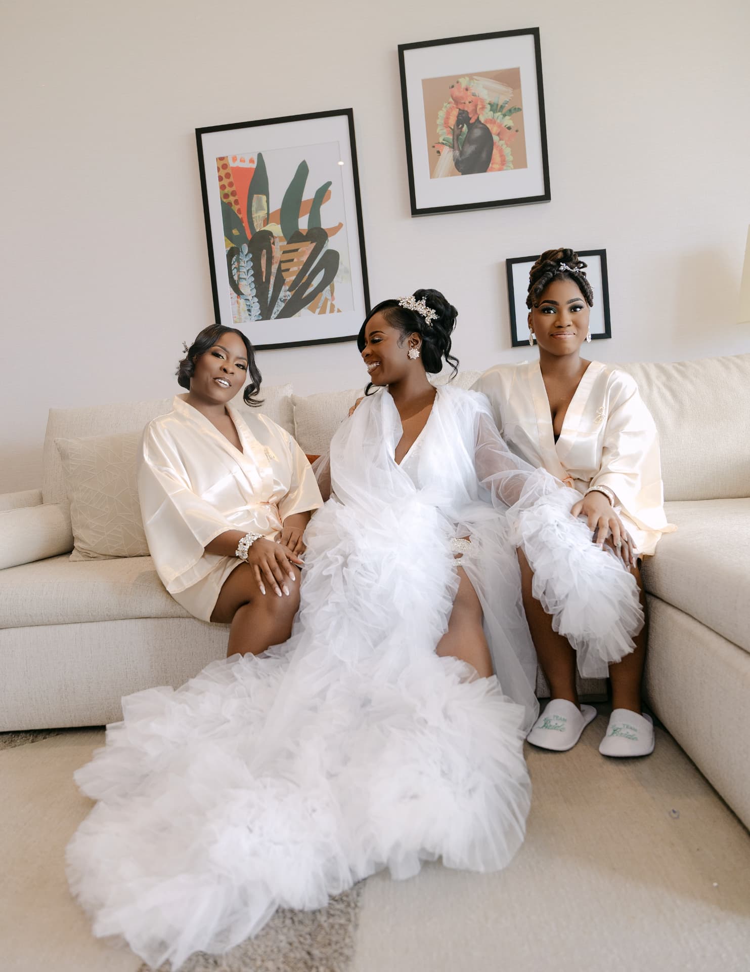 Bride and her closest people in robes on a sofa